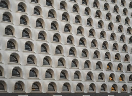 Lots of elliptical windows on a modern white building